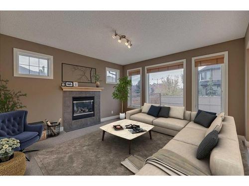 3 Evergreen Square Sw, Calgary, AB - Indoor Photo Showing Living Room With Fireplace