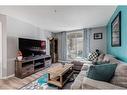 2120-60 Panatella Street Nw, Calgary, AB  - Indoor Photo Showing Living Room 