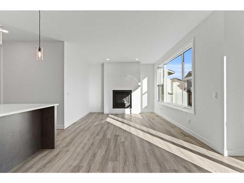 203 Kinniburgh Loop, Chestermere, AB - Indoor Photo Showing Living Room With Fireplace