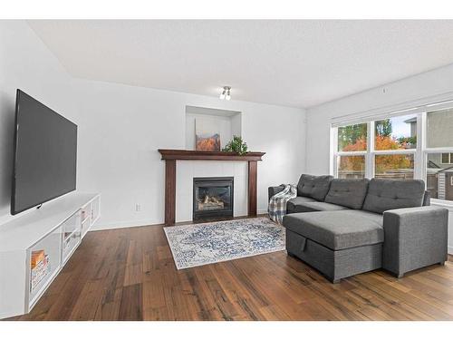 8 Bridleridge Lane Sw, Calgary, AB - Indoor Photo Showing Living Room With Fireplace