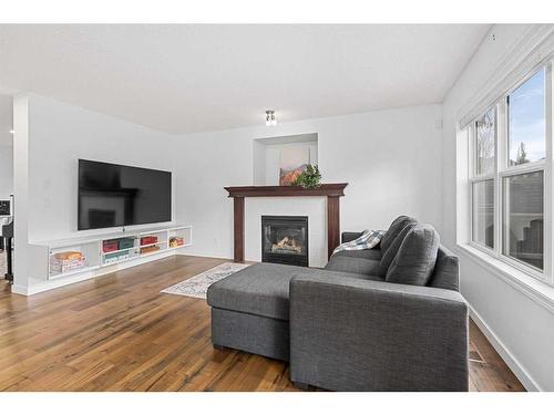 8 Bridleridge Lane Sw, Calgary, AB - Indoor Photo Showing Living Room With Fireplace