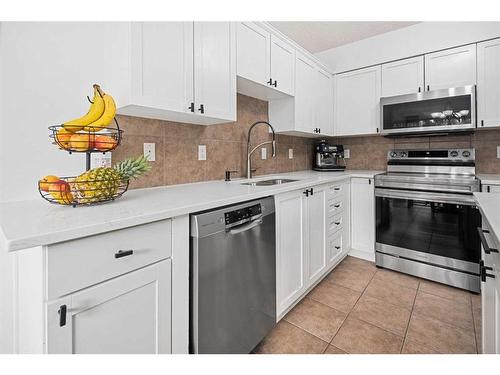 8 Bridleridge Lane Sw, Calgary, AB - Indoor Photo Showing Kitchen With Stainless Steel Kitchen With Double Sink