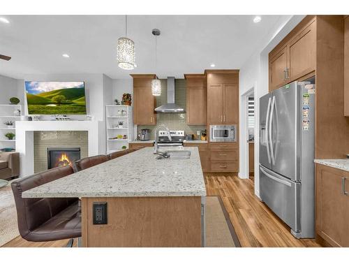 89 Saddlestone Place Ne, Calgary, AB - Indoor Photo Showing Kitchen With Fireplace With Stainless Steel Kitchen