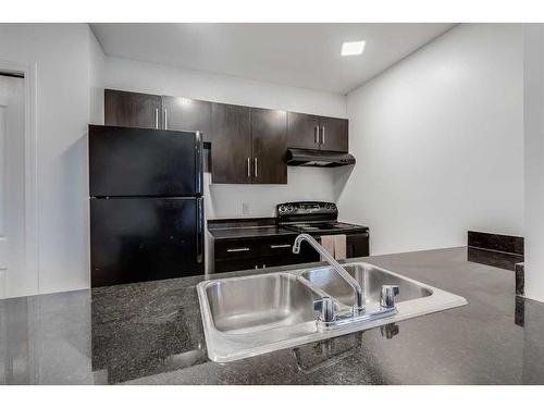 119-7210 80 Avenue Ne, Calgary, AB - Indoor Photo Showing Kitchen With Double Sink