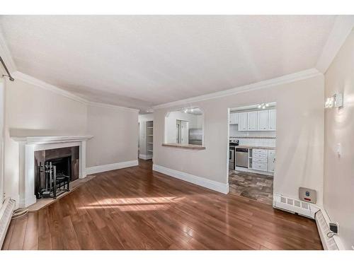 401-1817 11 Avenue Sw, Calgary, AB - Indoor Photo Showing Living Room With Fireplace