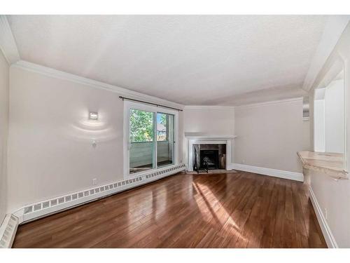 401-1817 11 Avenue Sw, Calgary, AB - Indoor Photo Showing Living Room With Fireplace