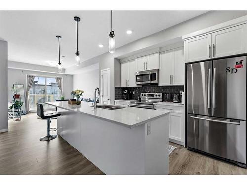 418-4150 Seton Drive Se, Calgary, AB - Indoor Photo Showing Kitchen With Stainless Steel Kitchen With Double Sink With Upgraded Kitchen