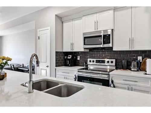 418-4150 Seton Drive Se, Calgary, AB - Indoor Photo Showing Kitchen With Stainless Steel Kitchen With Double Sink With Upgraded Kitchen