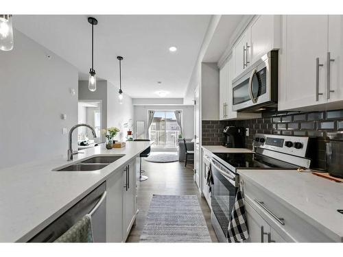 418-4150 Seton Drive Se, Calgary, AB - Indoor Photo Showing Kitchen With Stainless Steel Kitchen With Double Sink With Upgraded Kitchen