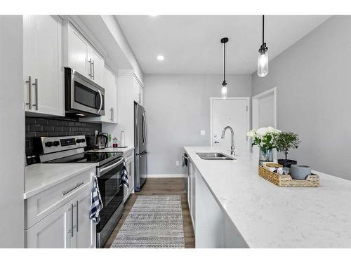 418-4150 Seton Drive Se, Calgary, AB - Indoor Photo Showing Kitchen With Stainless Steel Kitchen With Double Sink With Upgraded Kitchen