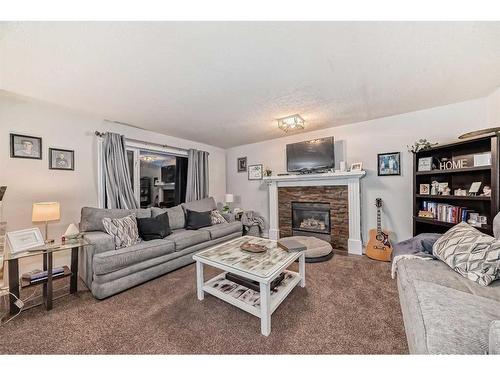 25 Cimarron Crescent, Okotoks, AB - Indoor Photo Showing Living Room With Fireplace