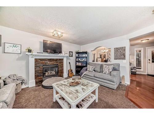 25 Cimarron Crescent, Okotoks, AB - Indoor Photo Showing Living Room With Fireplace