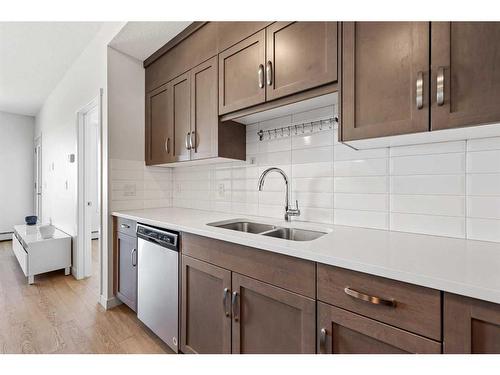 401-30 Shawnee Common Sw, Calgary, AB - Indoor Photo Showing Kitchen With Stainless Steel Kitchen With Double Sink With Upgraded Kitchen