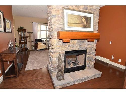 61 Big Hill Springs Estates, Rural Rocky View County, AB - Indoor Photo Showing Living Room With Fireplace