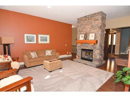 61 Big Hill Springs Estates, Rural Rocky View County, AB - Indoor Photo Showing Living Room With Fireplace