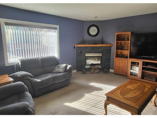 7819 34 Avenue Nw, Calgary, AB - Indoor Photo Showing Living Room With Fireplace