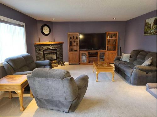 7819 34 Avenue Nw, Calgary, AB - Indoor Photo Showing Living Room With Fireplace