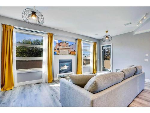 4735 17 Avenue Nw, Calgary, AB - Indoor Photo Showing Living Room With Fireplace