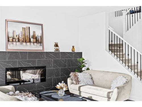 935 Langholm Drive Se, Airdrie, AB - Indoor Photo Showing Living Room With Fireplace