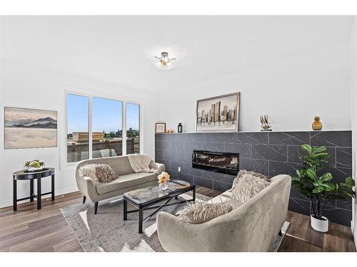 935 Langholm Drive Se, Airdrie, AB - Indoor Photo Showing Living Room With Fireplace