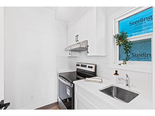 935 Langholm Drive Se, Airdrie, AB - Indoor Photo Showing Kitchen