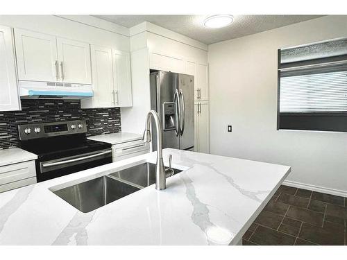 74 Pennsburg Way Se, Calgary, AB - Indoor Photo Showing Kitchen With Double Sink