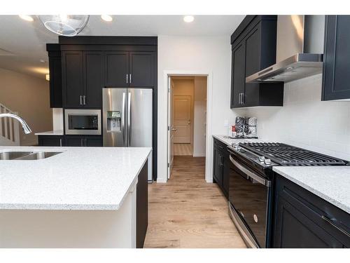 1309 Bayview Point Sw, Airdrie, AB - Indoor Photo Showing Kitchen With Stainless Steel Kitchen With Double Sink With Upgraded Kitchen