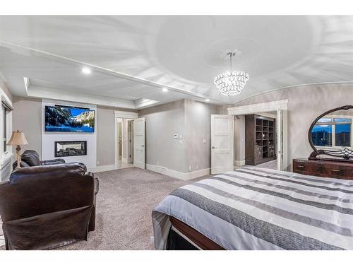 32 Aspen Ridge Manor Sw, Calgary, AB - Indoor Photo Showing Bedroom With Fireplace