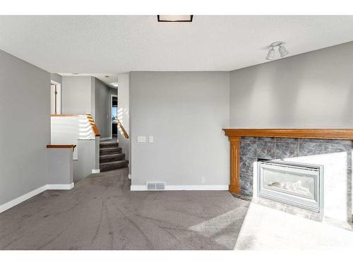 16161 Shawbrooke Road Sw, Calgary, AB - Indoor Photo Showing Living Room With Fireplace