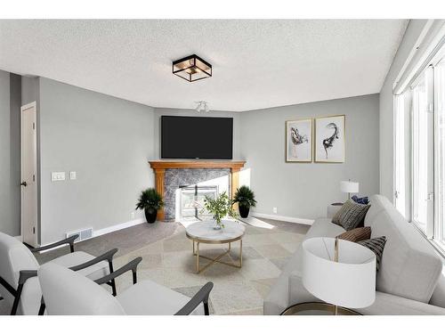 16161 Shawbrooke Road Sw, Calgary, AB - Indoor Photo Showing Living Room With Fireplace