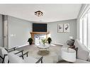 16161 Shawbrooke Road Sw, Calgary, AB  - Indoor Photo Showing Living Room With Fireplace 