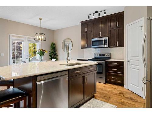 73 Kingsbridge Place Se, Airdrie, AB - Indoor Photo Showing Kitchen With Double Sink With Upgraded Kitchen