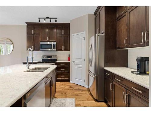 73 Kingsbridge Place Se, Airdrie, AB - Indoor Photo Showing Kitchen With Double Sink With Upgraded Kitchen