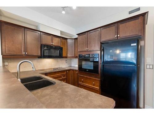 344-26 Val Gardena View Sw, Calgary, AB - Indoor Photo Showing Kitchen With Double Sink