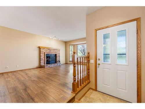 71 Quigley Drive, Cochrane, AB - Indoor Photo Showing Other Room With Fireplace