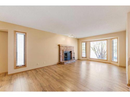 71 Quigley Drive, Cochrane, AB - Indoor Photo Showing Living Room With Fireplace