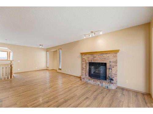 71 Quigley Drive, Cochrane, AB - Indoor Photo Showing Living Room With Fireplace