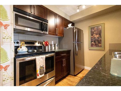 2408-625 Glenbow Drive, Cochrane, AB - Indoor Photo Showing Kitchen With Stainless Steel Kitchen With Double Sink