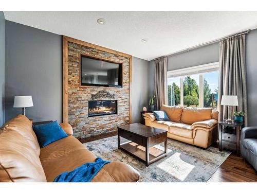 228 Stonegate Place Nw, Airdrie, AB - Indoor Photo Showing Living Room With Fireplace