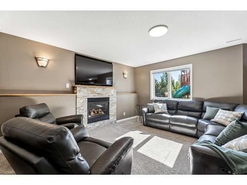 228 Stonegate Place Nw, Airdrie, AB - Indoor Photo Showing Living Room With Fireplace