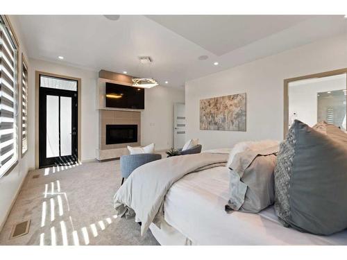 275 Dalhurst Way Nw, Calgary, AB - Indoor Photo Showing Bedroom With Fireplace