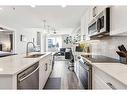 113-8530 8A Avenue Sw, Calgary, AB  - Indoor Photo Showing Kitchen With Stainless Steel Kitchen With Double Sink With Upgraded Kitchen 