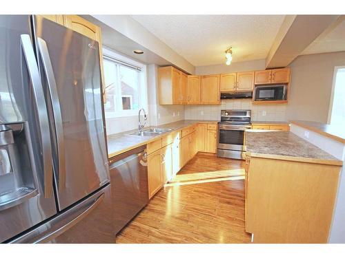 2 Bridlecrest Gardens Sw, Calgary, AB - Indoor Photo Showing Kitchen With Stainless Steel Kitchen With Double Sink