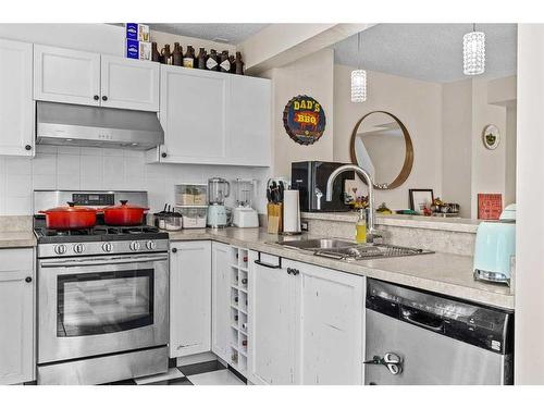 224 Jasper Way, Banff, AB - Indoor Photo Showing Kitchen With Double Sink