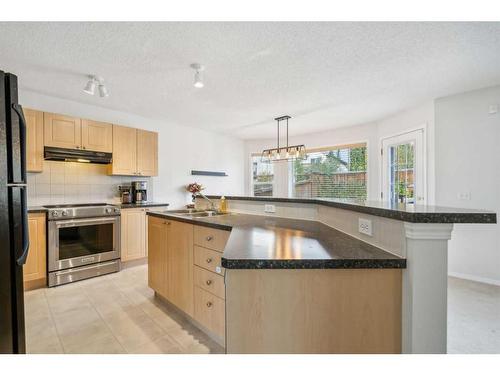 157 Evansmeade Circle Nw, Calgary, AB - Indoor Photo Showing Kitchen With Double Sink