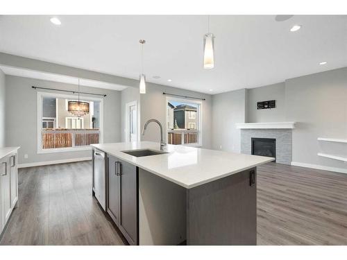 628 Midtown Place Sw, Airdrie, AB - Indoor Photo Showing Kitchen With Fireplace With Upgraded Kitchen