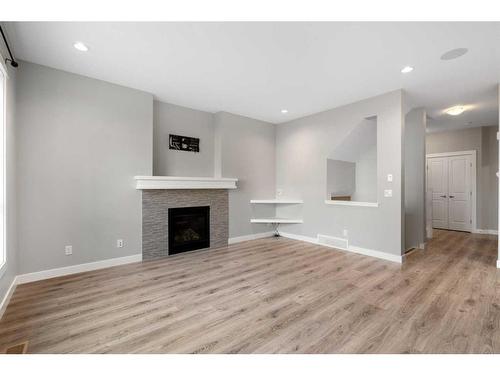 628 Midtown Place Sw, Airdrie, AB - Indoor Photo Showing Living Room With Fireplace