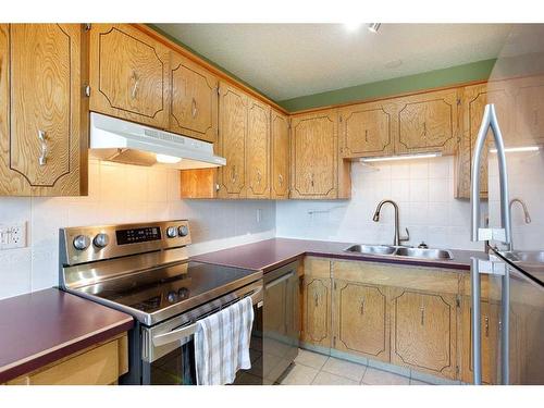 103 Ranch Glen Place Nw, Calgary, AB - Indoor Photo Showing Kitchen With Double Sink