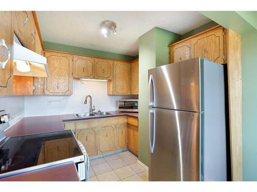 103 Ranch Glen Place Nw, Calgary, AB - Indoor Photo Showing Kitchen With Double Sink