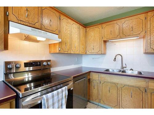 103 Ranch Glen Place Nw, Calgary, AB - Indoor Photo Showing Kitchen With Double Sink